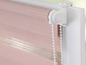 Růžová a bílá pruhovaná roleta s bílým tažným šňůrkem.