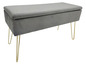 Šedá sametová lavice s úložným prostorem a zlatými nohami.