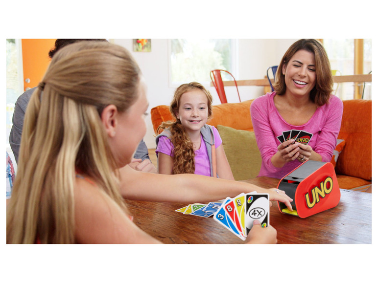 Skupina lidí hraje karetní hru UNO.