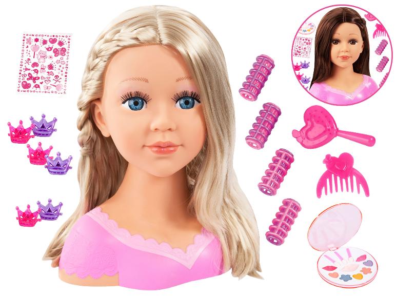 Blonďatá stylingová hlava s make-upem, natáčkami, hřebenem, kartáčem, korunkovými sponkami a samolepkami.