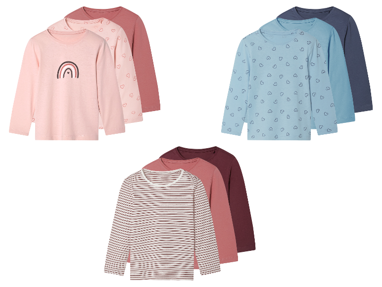 Tři sady dětských triček s dlouhým rukávem s různými vzory: duha, srdíčka a proužky.