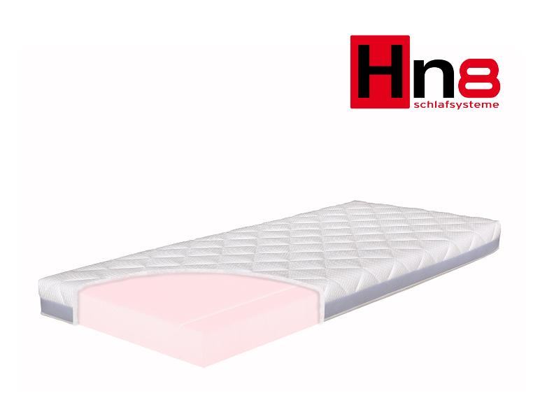 Matrace Hn8 Schlafsysteme s viditelným růžovým pěnovým jádrem.