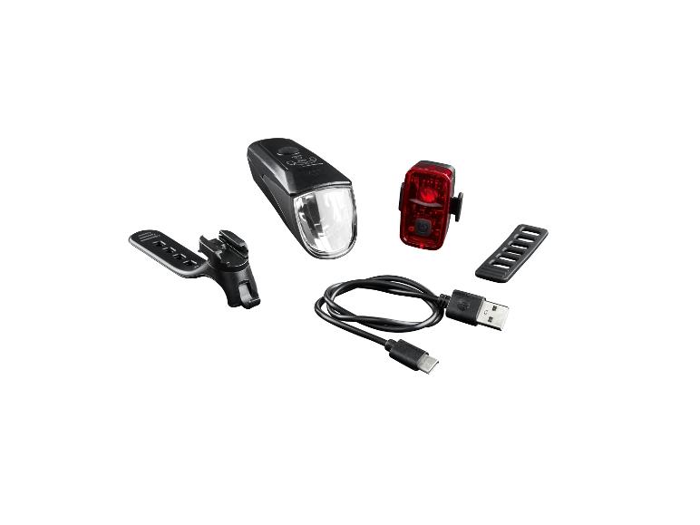 Sada cyklistických světel s předním a zadním světlem, včetně USB kabelu a montážních prvků.