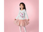 Dívka v bílém tričku s Hello Kitty a růžovou tylovou sukní.