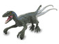 Hračka dinosaura velociraptora v zelené a modré barvě na kolečkách.