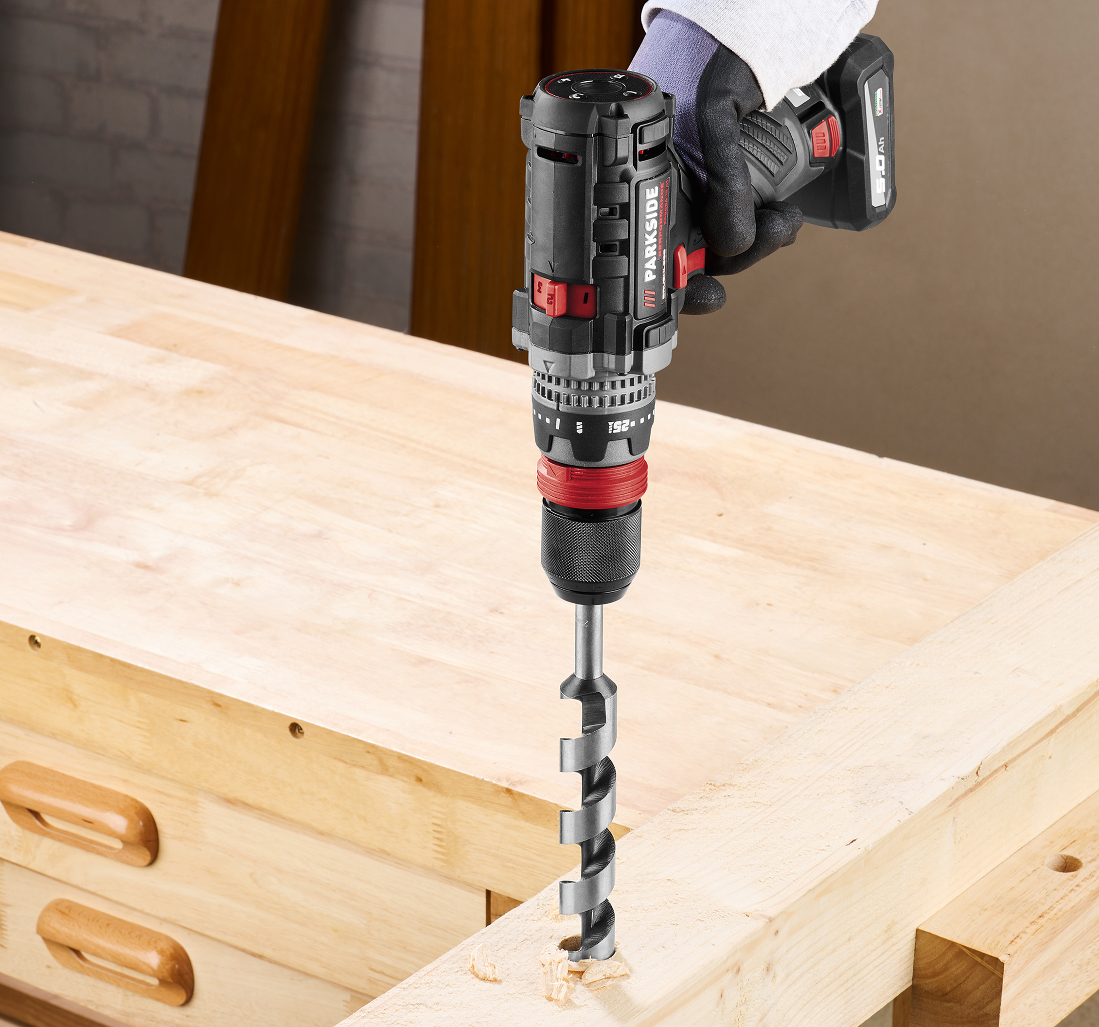 Акумуляторний дриль Parkside свердлить деревину.