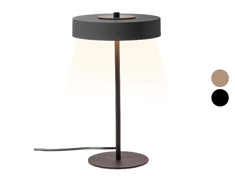 Stolní lampa s tmavě šedým stínidlem a podstavcem, vyzařující teplé světlo, s barevnými vzorky.
