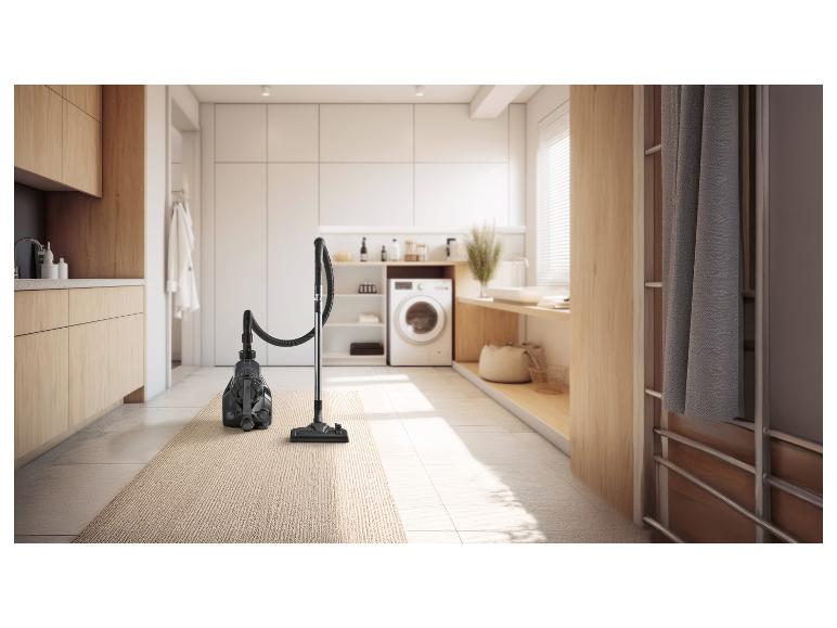 Vysavač na koberci v moderní prádelně.