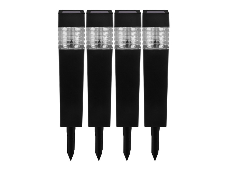 Tři černé solární zahradní lampy s LED osvětlením.