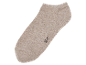 Béžová ponožka na černém pozadí.