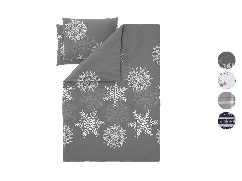 Šedé povlečení s bílými vzory sněhových vloček a čtyřmi vzorky látek.