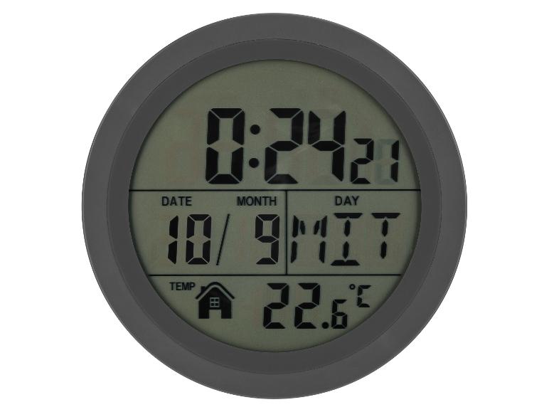 Kulaté digitální hodiny zobrazující čas, datum a teplotu.