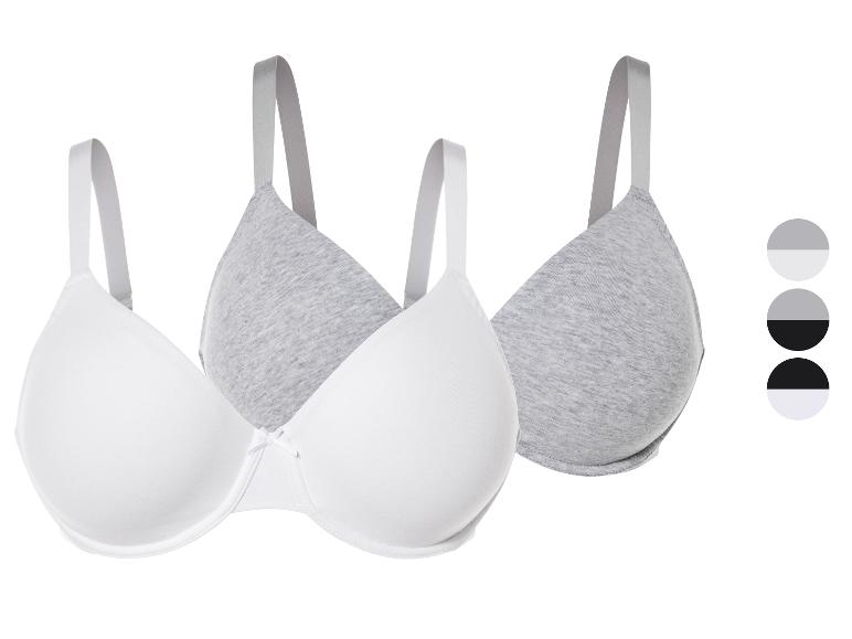 Dvě podprsenky, bílá a šedá.