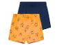 Dvoje dětské šortky: oranžové s potiskem tygrů a tmavě modré jednobarevné.
