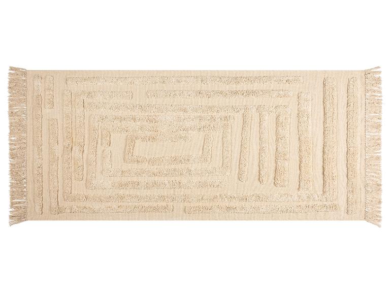 Béžový obdélníkový koberec s reliéfním geometrickým vzorem a třásněmi.