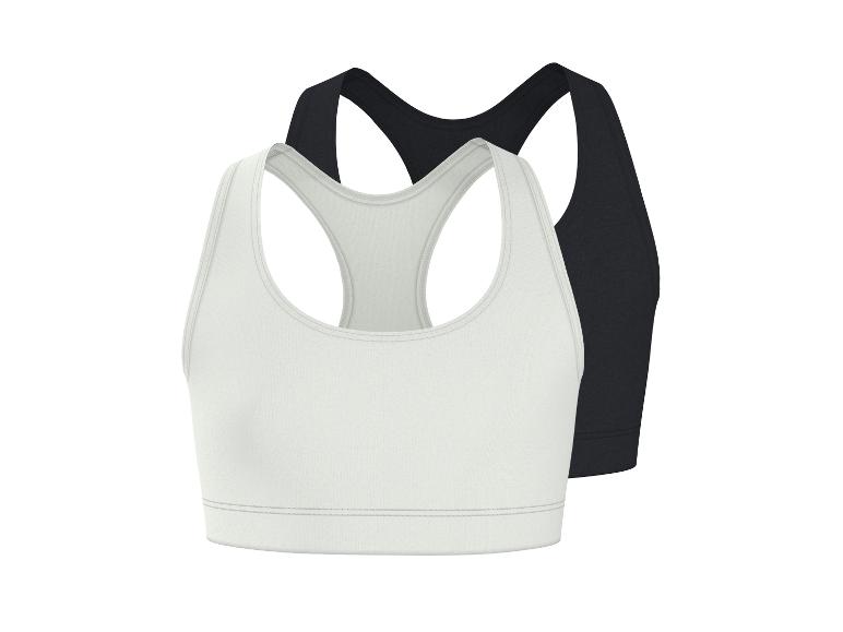 Dvě sportovní podprsenky, jedna bílá a jedna černá, s designem racerback.