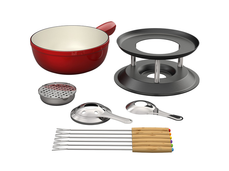 Červený hrnec na fondue se stojanem, hořákem a vidličkami na fondue.