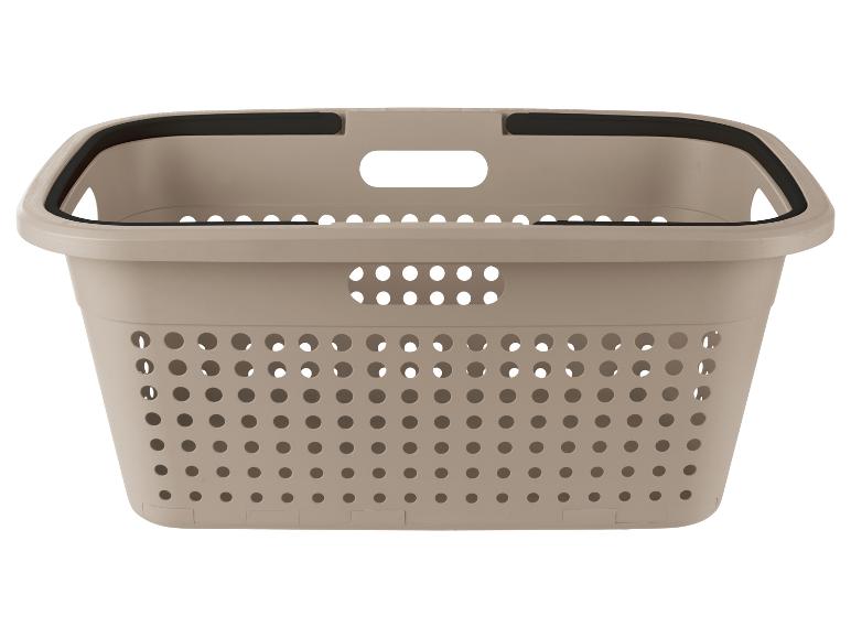 Béžový koš na prádlo s černým okrajem a rukojetí