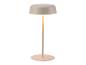 Moderní, minimalistická béžová stolní lampa s kulatou základnou a svítícím stínidlem.
