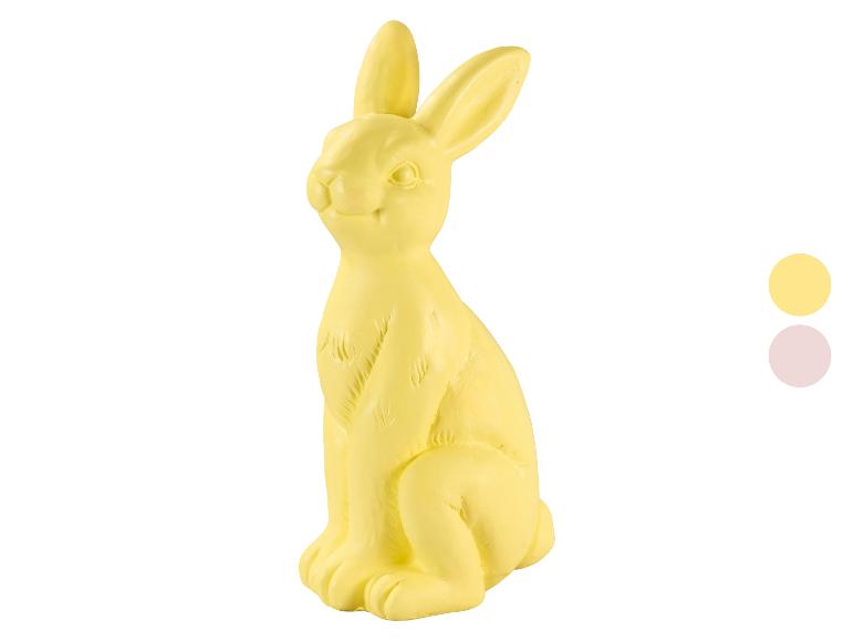 Žlutá figurka velikonočního zajíčka se dvěma vzorky barev vpravo.