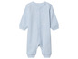 Světle modrá dětská kombinéza s knoflíky.