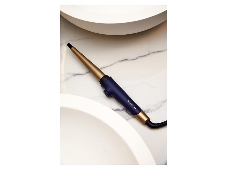 Kulma Remington, zlatá a tmavě modrá, na mramoru.