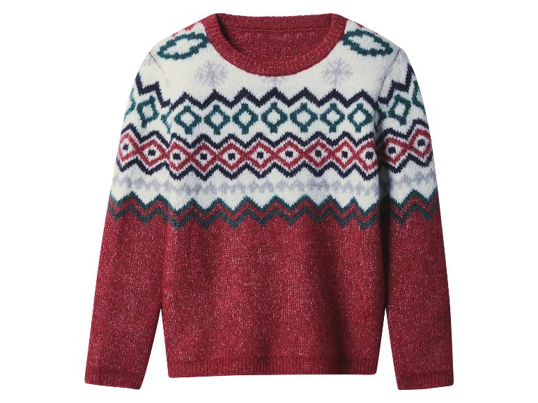 Červený svetr s Fair Isle vzorem, s bílými, modrými a červenými geometrickými vzory.