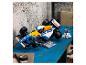Závodní auto Lego Williams-Renault FW14B na modrém stole, s minifigurkou.