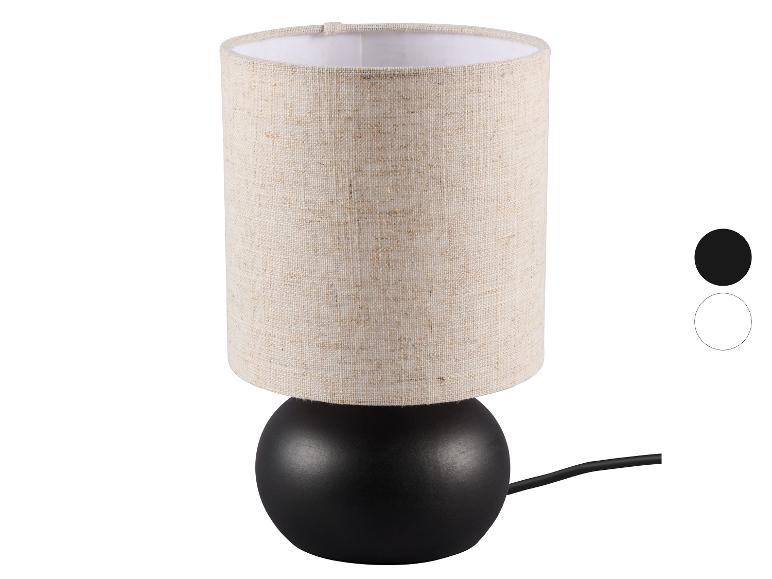 Stolní lampa s béžovým látkovým stínítkem a černou základnou, s barevnými možnostmi.