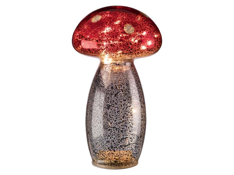 Červená houbová lampa se skvrnitou stříbrnou základnou.