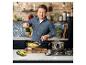 Jamie Oliver vaří těstoviny v kuchyni s cihlovými zdmi a mramorovými deskami
