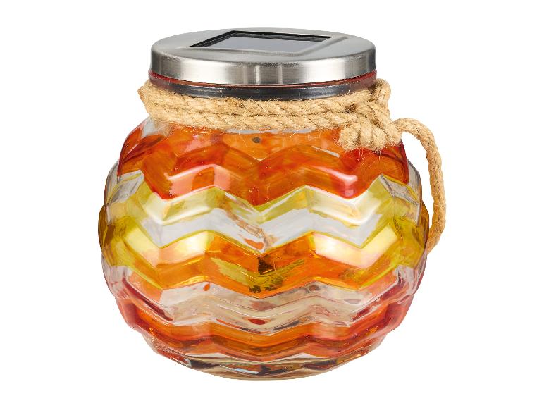 Skleněná solární lampa s cikcakovým vzorem.