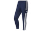 Modré tepláky Adidas s bílými pruhy.