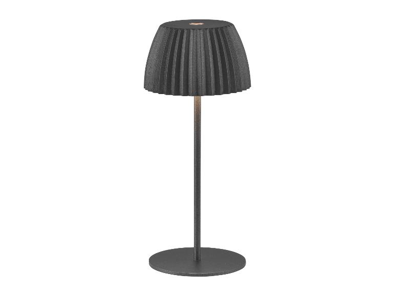 Moderní stolní lampa s plisovaným stínidlem a kulatou základnou.