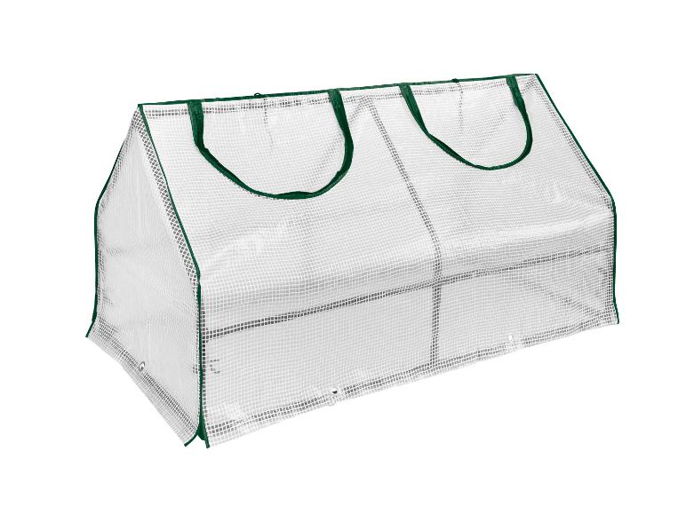 Malý skleník z bílého plastu se zelenými okraji.