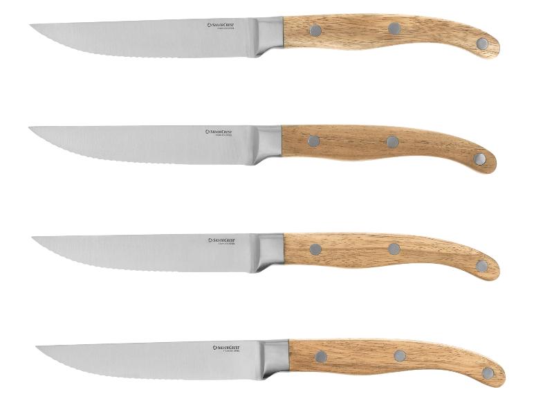 Sada čtyř steakových nožů se zubatými čepelemi a dřevěnými rukojeťmi.