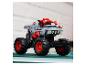 Šedý a červený model monster trucku s velkými koly a žraločími zuby.