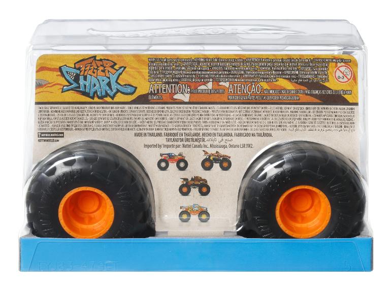 Obal na hračku monster truck s velkými koly a výstražnými štítky.