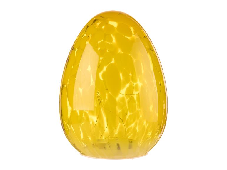 Žlutá skleněná lampa ve tvaru vejce.