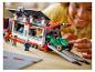 Usmívající se dítě si hraje s LEGO sadou přepravníku závodních aut.