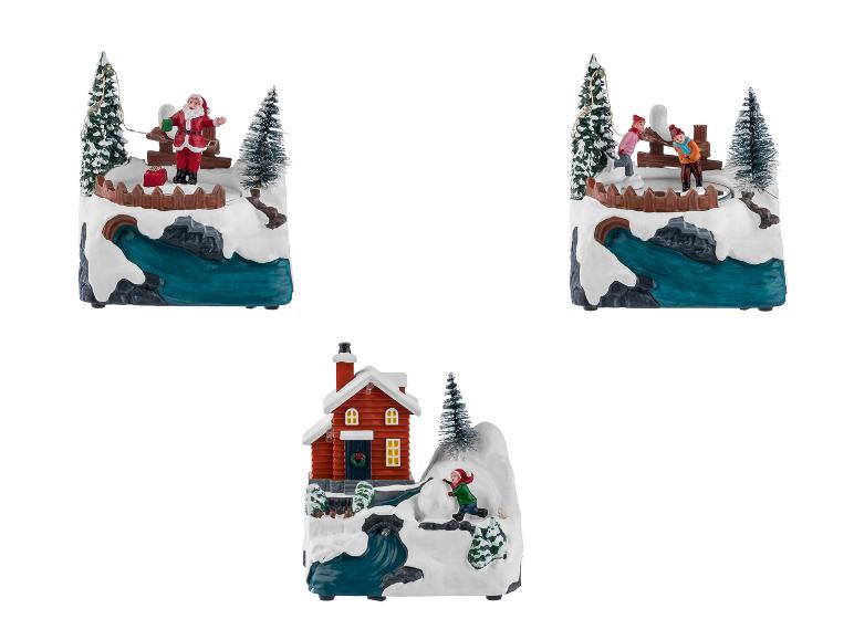 Vánoční dekorace s Santa Clausem, bruslaři a domečkem.