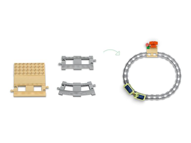 Sada Lego Duplo vláčkodráhy s rovnými a zakřivenými kolejemi, vagónem a stanicí.