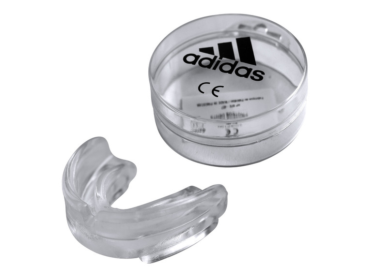 Průhledný chránič zubů Adidas v plastové krabičce.