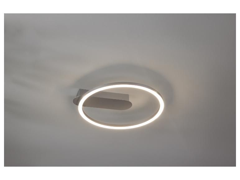 Kulatá LED nástěnná lampa s kovovým rámem.
