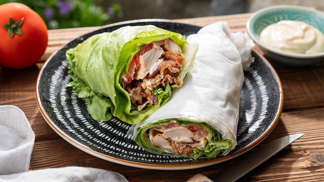 Saláty v listech salátu s kuřecím masem a slaninou.