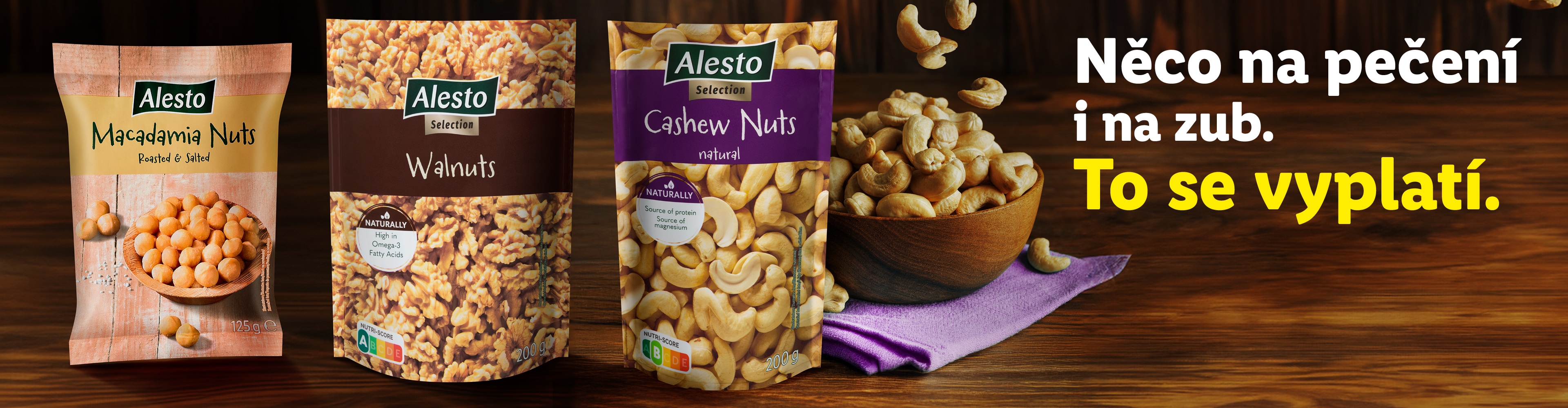 Alesto makadamové ořechy, vlašské ořechy a kešu ořechy s textem „Něco na pečení i na zub. To se vyplatí.“