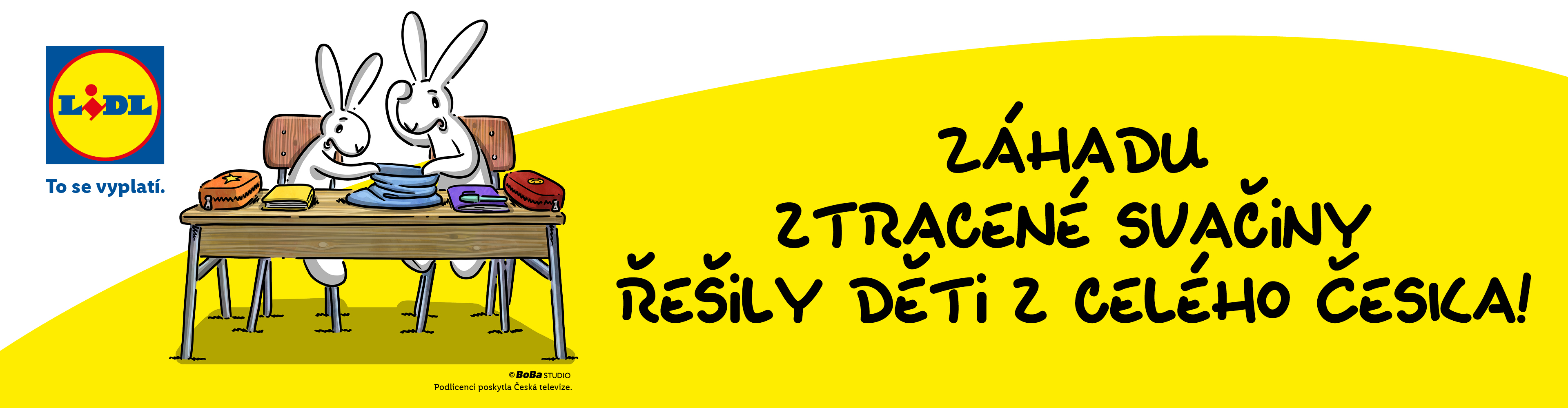 Dva králíci sedí u stolu s učebnicemi a svačinou. Text: To se vyplatí. Záhadu ztracené svačiny řešily děti z celého Česka!